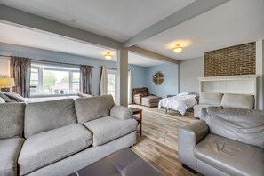 Un amplio espacio habitable con un sofá, una cama y una chimenea.