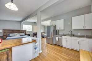 A modern kitchen with white cabinets, stainless steel appliances, and a wooden countertop. - Couples Outdoor Retreat Near Garden of the Gods (Colorado Springs)