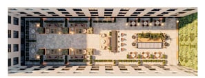 A rooftop terrace with multiple seating areas, a central dining space, and a vertical garden.