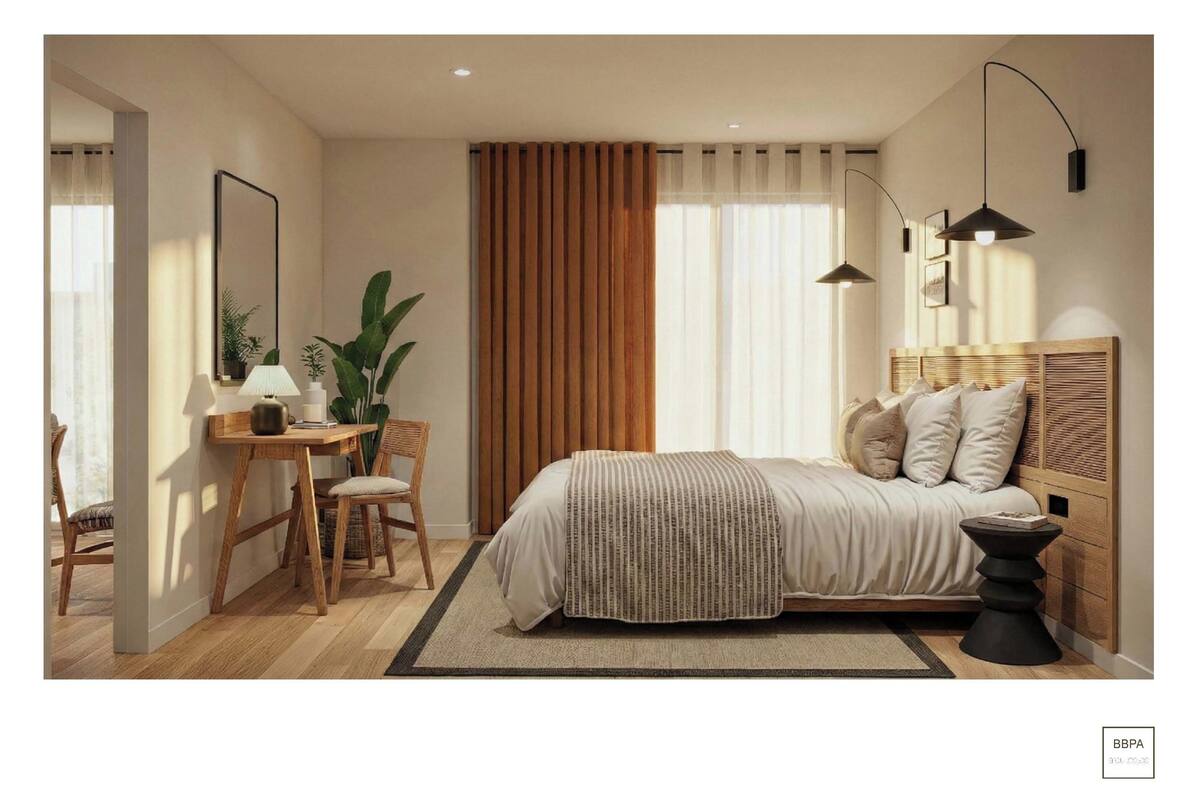 A bedroom with a bed, bedside table, lamp, chair, and curtains.