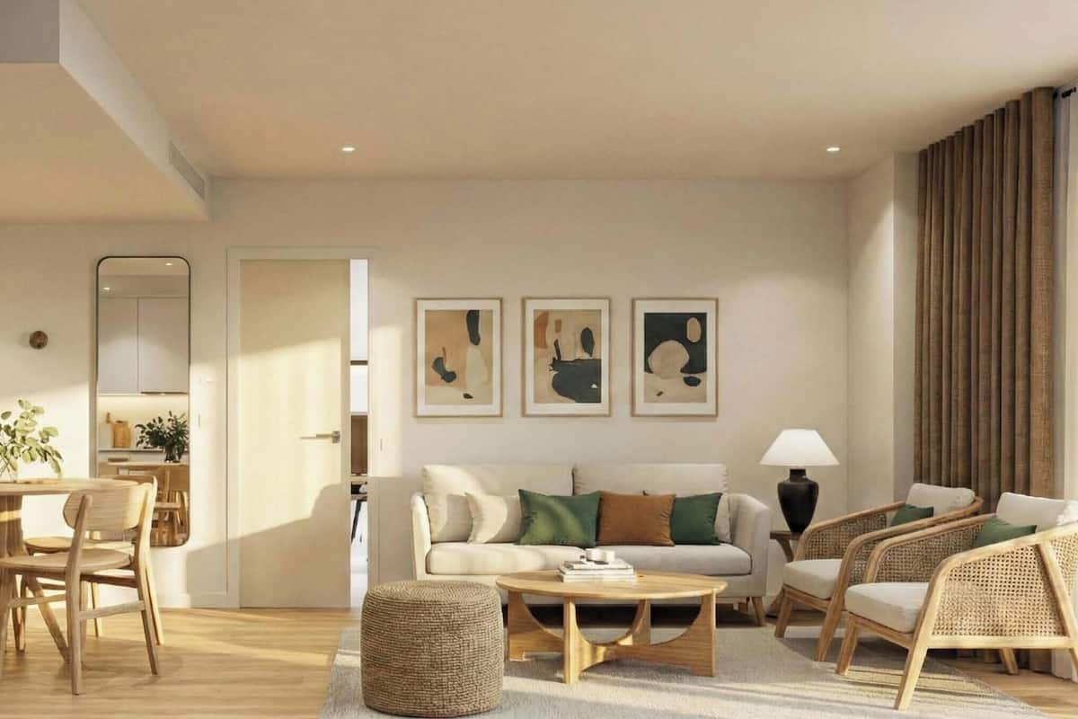 A modern living room with a sofa, chairs, a coffee table, and artwork on the wall.