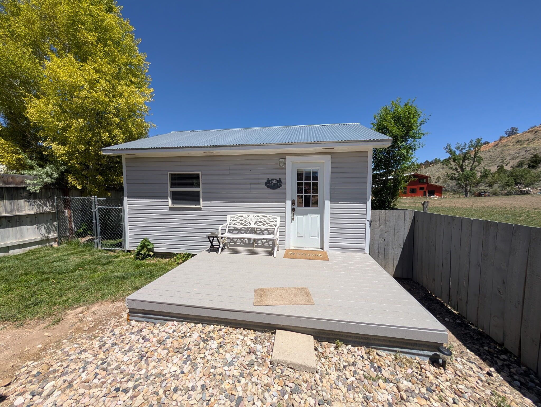 A small, single-story house with a front porch, a small window, and a door.. Stan's Hideaway in Tropic 9 miles to Bryce Canyon, Tucked away & private, Unique