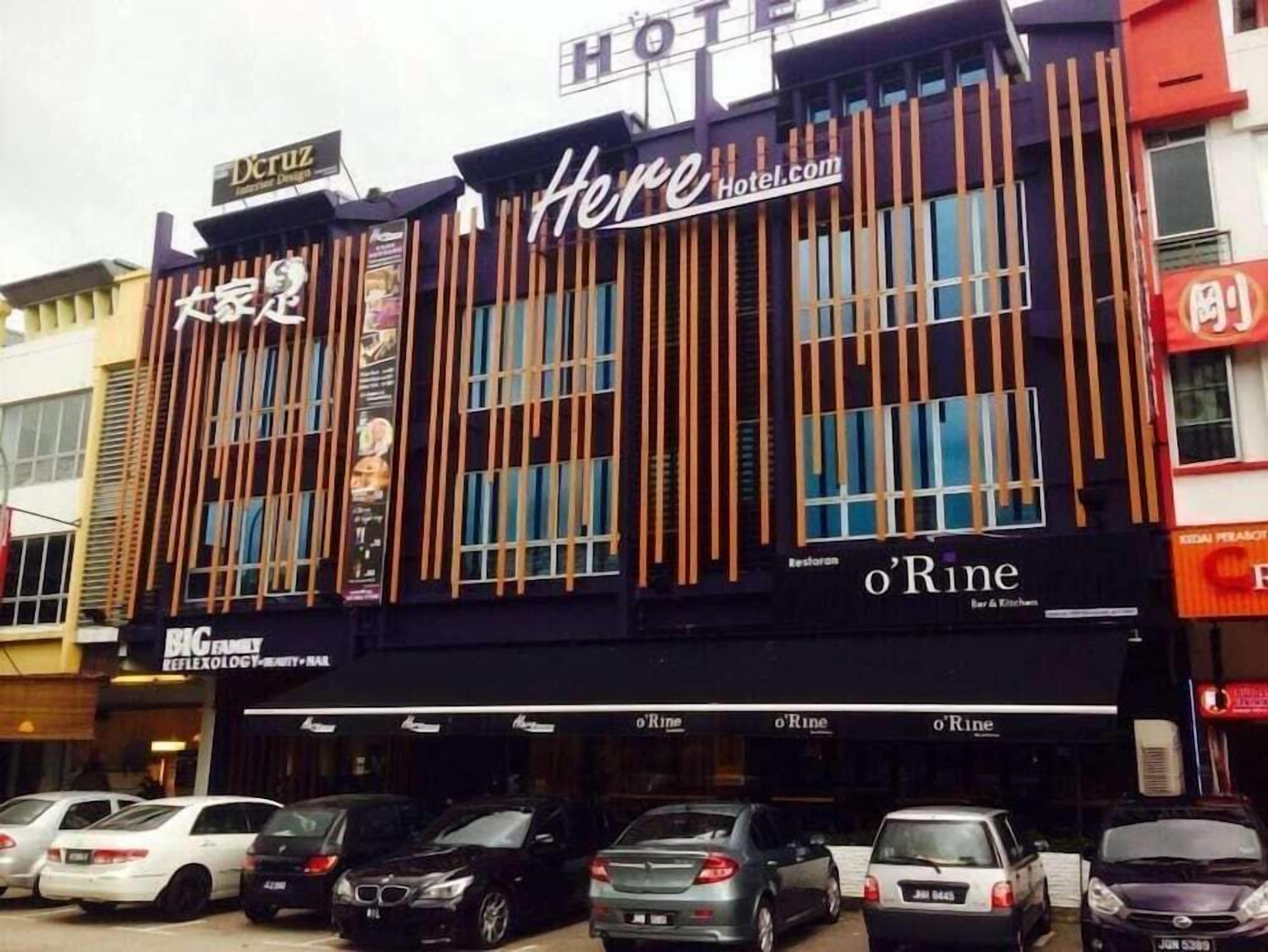 A hotel with a sign reading 'Here Hotel.com' and 'o'Rine Bar & Kitchen' on the ground floor.