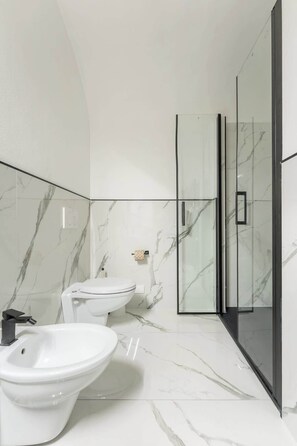 A modern bathroom with a glass shower enclosure, a toilet, and a bidet. - Egidio Spacious and bright 300mt from the Duomo (Firenze)