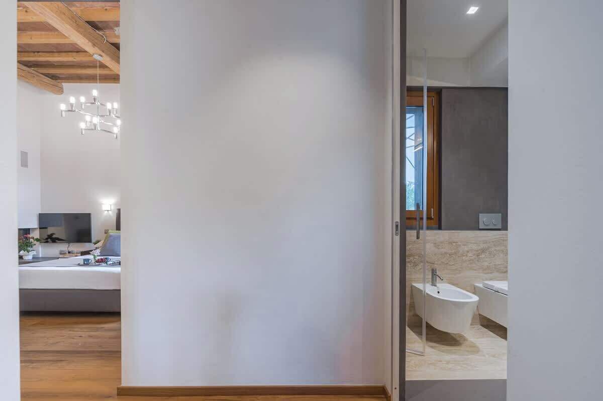 A modern bathroom with a freestanding bathtub, a sink, and a glass partition.