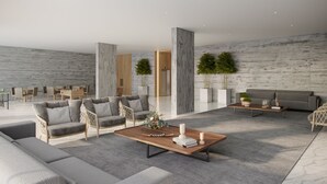 A modern living room with grey sofas, a wooden coffee table, and a grey patterned rug.