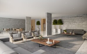Una sala de estar moderna con sofás grises, una mesa de centro de madera y una alfombra gris con estampado.