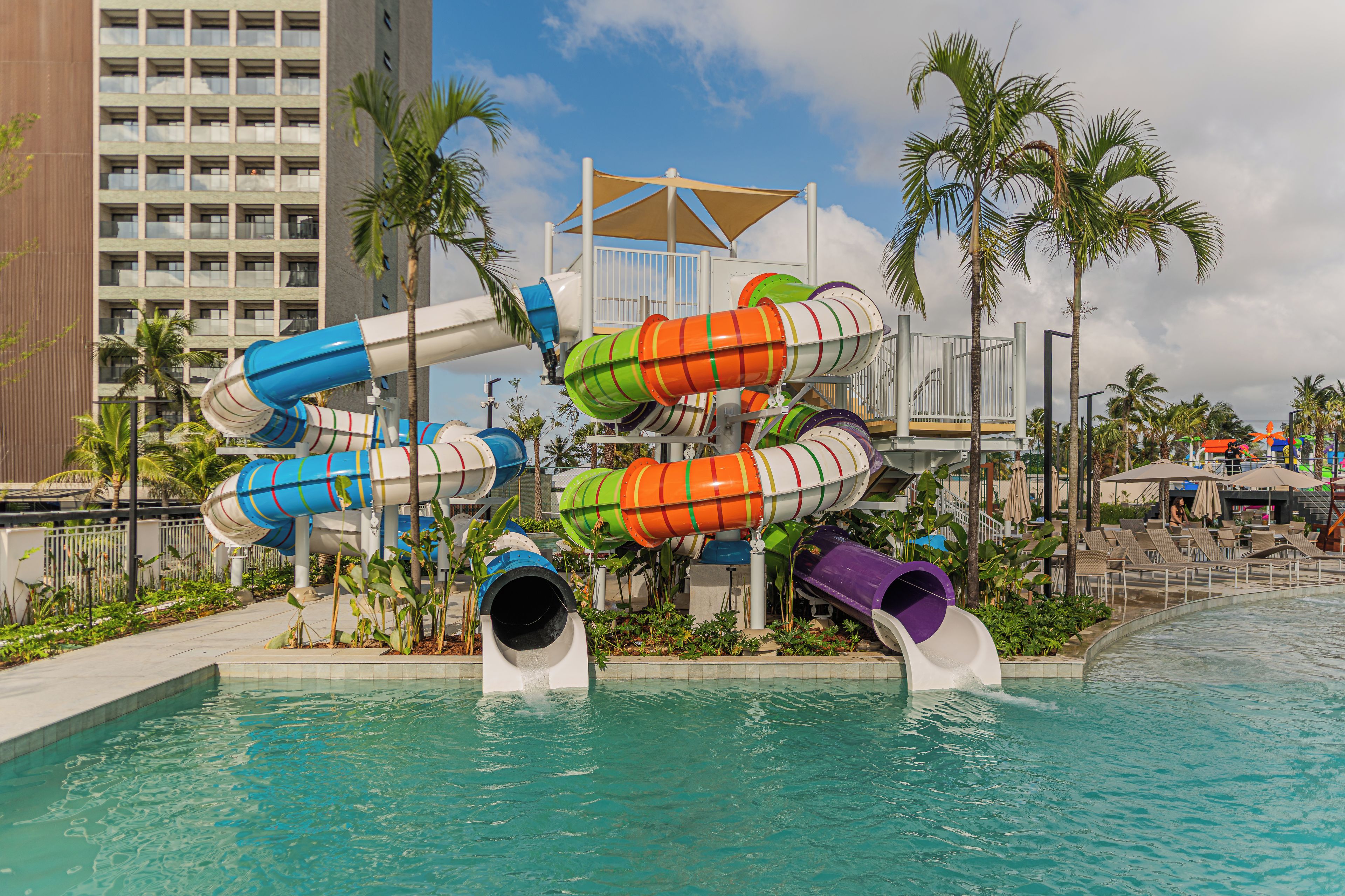 A water park with multiple slides and a pool.