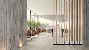 A modern interior with a wooden partition, a reception desk, and seating area.