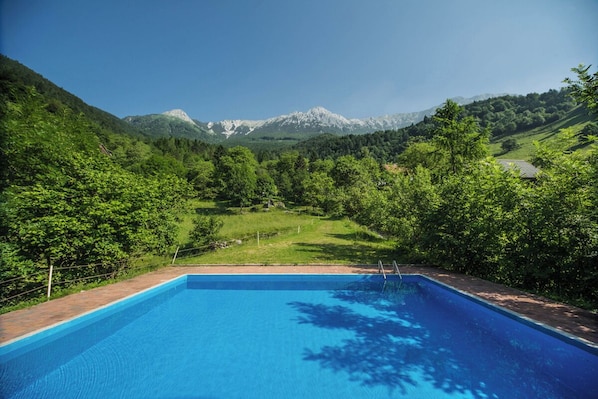 A swimming pool with a mountain view.
