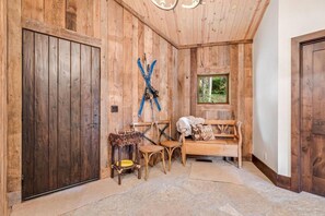 A wooden interior with a bench, chairs, skis, and a window. - Private Ski-out Village Home in Vail with Hot Tub (Vail)