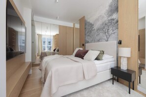 A modern bedroom with a large bed, a bedside table, a mirror, and a wall-mounted TV. - Spacious 3-Bedroom Apartment | Air Conditioning | Garage | Terrace (Warszawa)