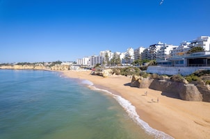 On the beach, white sand, beach cabanas, sun-loungers