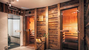 A sauna room with wooden walls, a bench, and a small table with towels. - Apartment 'Gästehaus Egger 1' with Mountain View, Balcony and Wi-Fi (Grossarl)