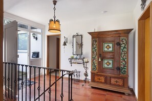 A hallway with a wooden cabinet, a hanging lamp, and a door leading to another room. - Holiday Home 'Leni' with Shared Terrace and Garden (Edertal)