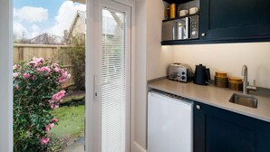 A kitchen with a built-in dishwasher, a toaster, and a sink. - Scaw Fell Boutique Studio Annex (Cowes)