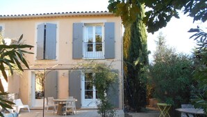 A two-story house with a swimming pool, outdoor furniture, and a garden. - Charming country house with private pool (Nyons)
