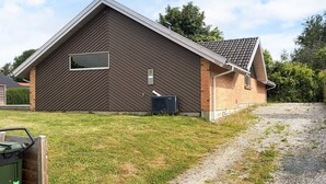 A single-story building with a sloped roof, a window, and a door. - 4 Star Holiday Home in Juelsminde (Horsens)