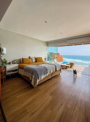 A bedroom with a large bed, a desk, and a view of the ocean. - Oceanview 2BR & Terrace in Punta Hermosa (Punta Hermosa)