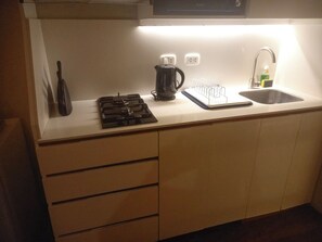 A kitchen with a stove, kettle, coffee maker, and a sink. - Oceanview 2BR & Terrace in Punta Hermosa (Punta Hermosa)