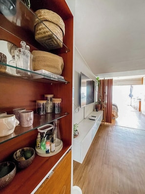 A modern kitchen with wooden shelves, a TV, and a view to the outside. - Oceanview 2BR & Terrace in Punta Hermosa (Punta Hermosa)