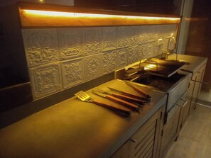 A kitchen with a countertop, a sink, and a backsplash with decorative tiles. - Oceanview 2BR & Terrace in Punta Hermosa (Punta Hermosa)