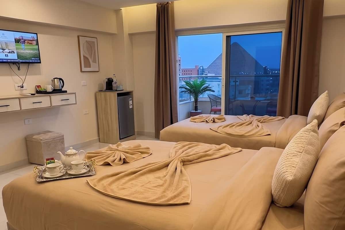 Deluxe Triple Room, Pyramid View | Minibar, in-room safe, blackout curtains, soundproofing