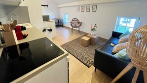A modern living space with a kitchen, dining area, and seating area. - Le 302 Sainte Ségolène (Metz)
