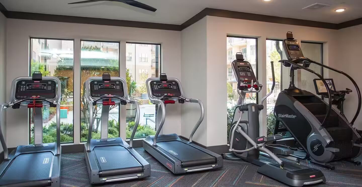 A gym with treadmills, a stair climber, and a stationary bike.