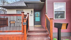 A wooden staircase leading to a front door with a mailbox and a small outdoor seating area. - 6 beds / close to SCSU, DT, & Lake George (St. Cloud)