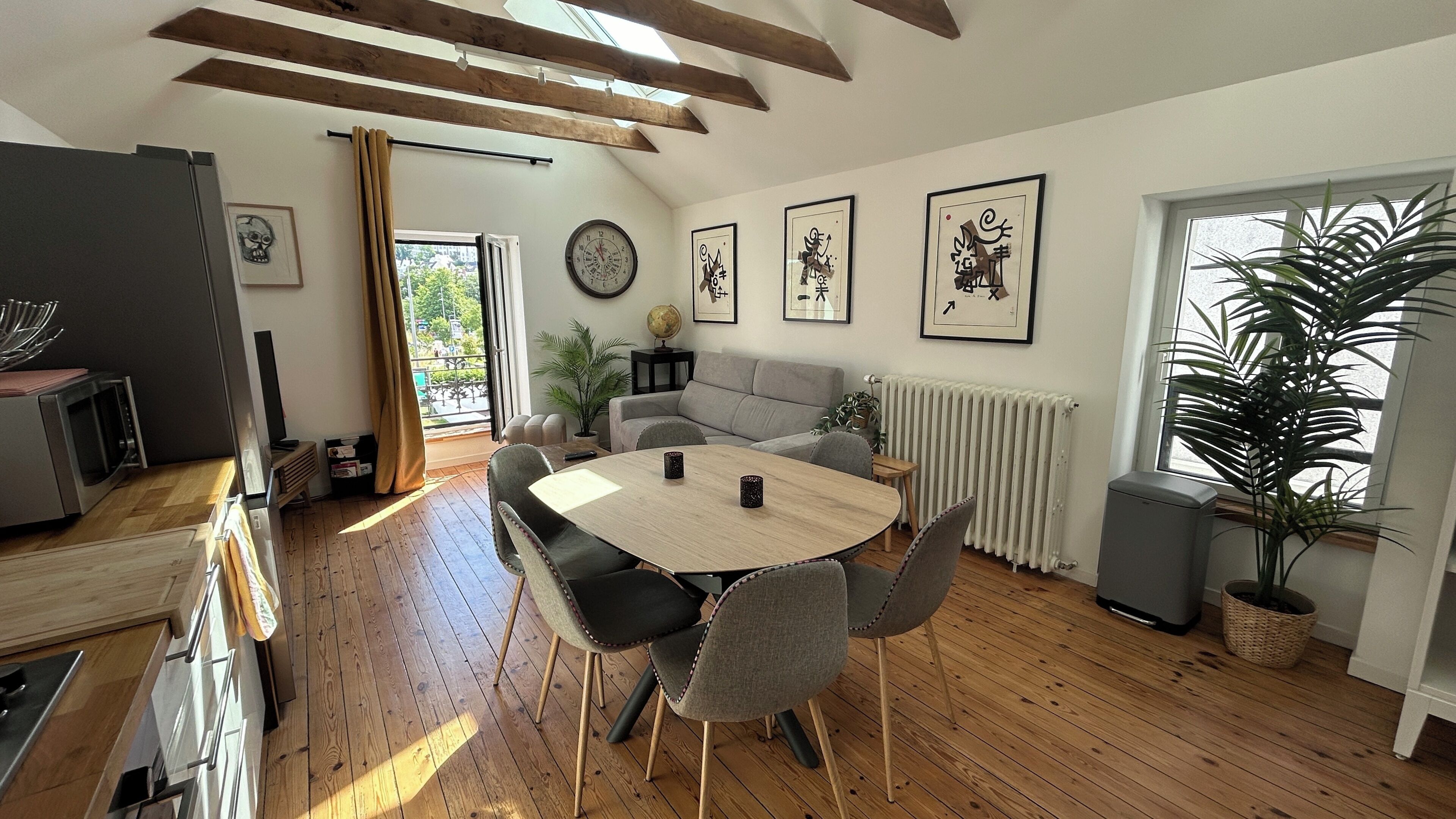 Une cuisine moderne équipée d’un four à micro-ondes, d’un four traditionnel et dotée d’un plancher en bois.