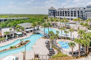 A hotel with a large swimming pool, palm trees, and a view of the ocean. - Henderson Beach Resort Lofts 205- Second Heaven (Destin)