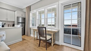 A kitchen with a dining area, a large window, and a view of the outside. - Henderson Beach Resort Lofts 411- Rooftop Retreat (Destin)