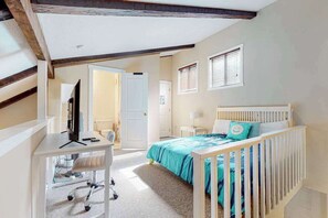 A bedroom with a bed, desk, chair, and a door leading to another room. - Dog-Friendly Gem with Pool, Hot Tub, Sauna & Deck (Tannersville)