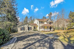A two-story house with a front porch, a garage, and a driveway. - Long Pond Home with Hot Tub, Billiards & Poker (Long Pond)