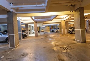 An underground parking garage with multiple levels, concrete pillars, and cars parked. - Stylish 1Oth Floor Studio with Great Views , Secure and Fast Wi-Fi (Kiambu Province)