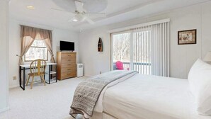 A bedroom with a bed, a desk, a chair, a dresser, a television, and a ceiling fan. - Rustic 3BR Cabin - HOT TUB - Oakland (Oakland)