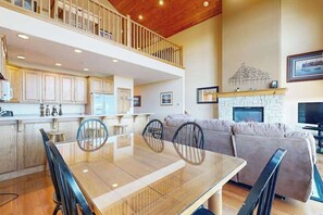 A spacious living area with a dining table, chairs, a sofa, and a fireplace. - Charming 3BR Townhouse - LAKE VIEW - McHenry (McHenry)