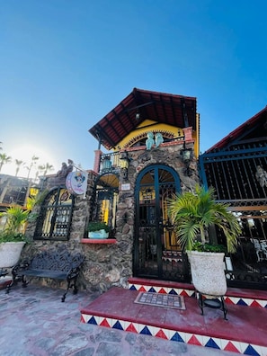 A building with a stone facade, a red roof, and a sign indicating a restaurant. - Casa Valentina-PezGallo Suite-Justo Centro & Beach (Loreto)