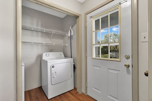 A laundry room with a washing machine, a drying rack, and a door with a window. - Country Living~ Horses, Wildlife & tranquility (Alvaton)