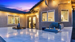 A patio with a grill, a dining area, and a view of the house. - Hercules by Avantstay Pool + Hot Tub + Fire Pit Near Indian Canyons (Palm Springs)