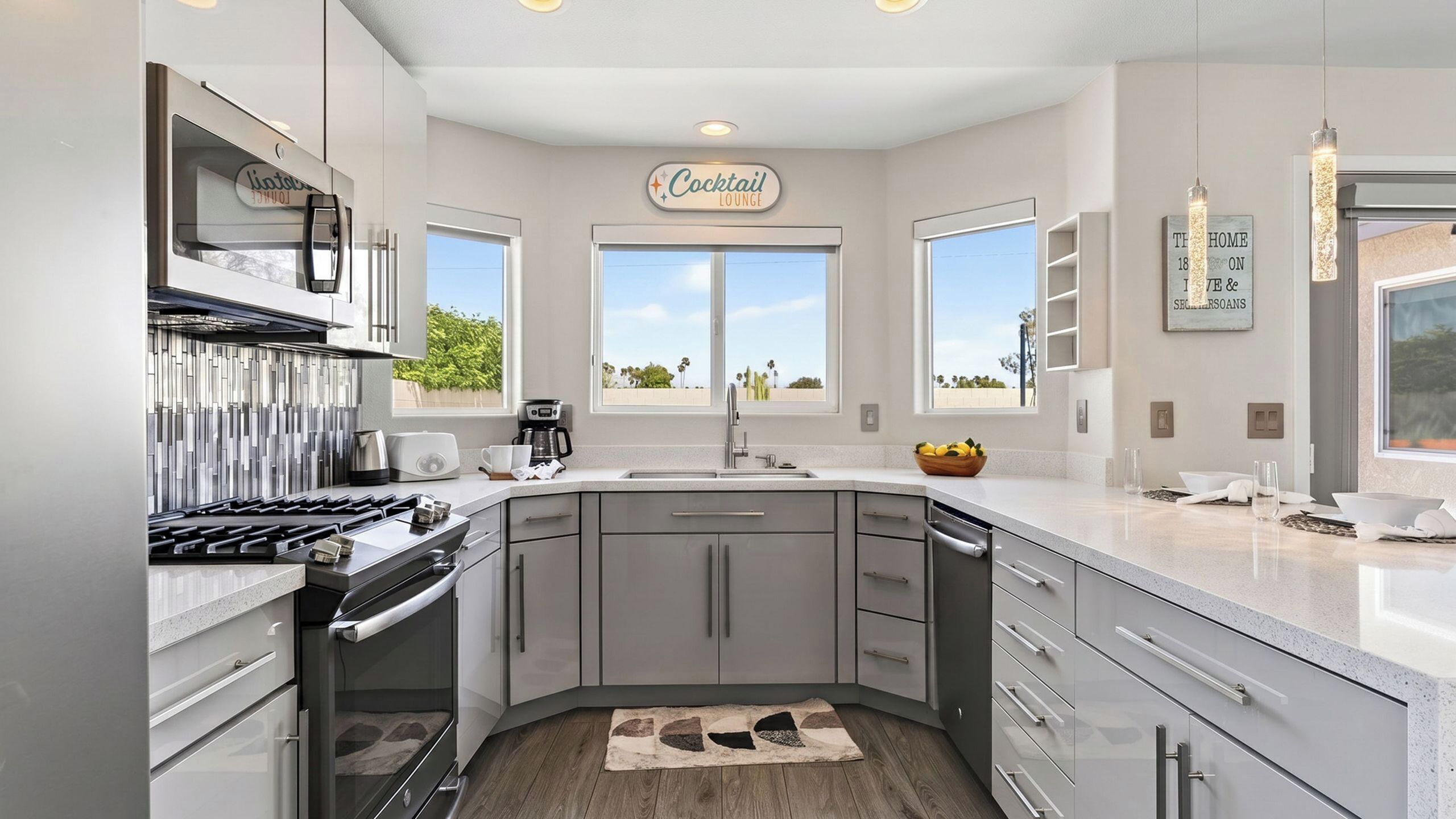 A modern kitchen with a built-in stove, a coffee maker, and a sign indicating a cocktail lounge.