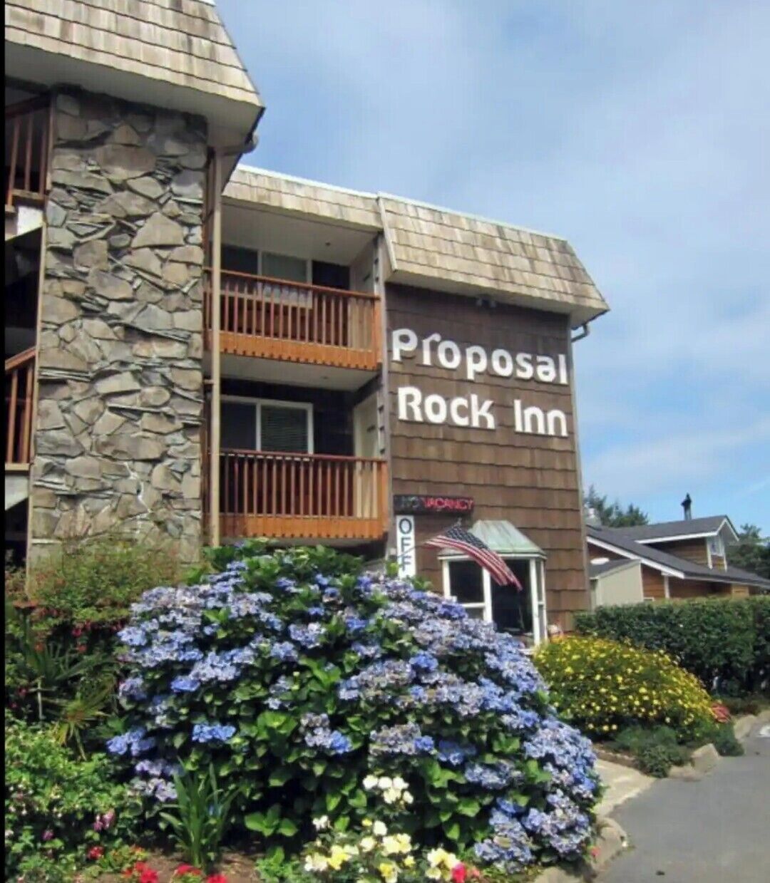 A building with a stone facade and a sign reading 'Proposal Rock Inn.'