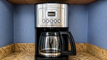 A Cuisinart coffee maker with a digital display, programmable settings, and a carafe.