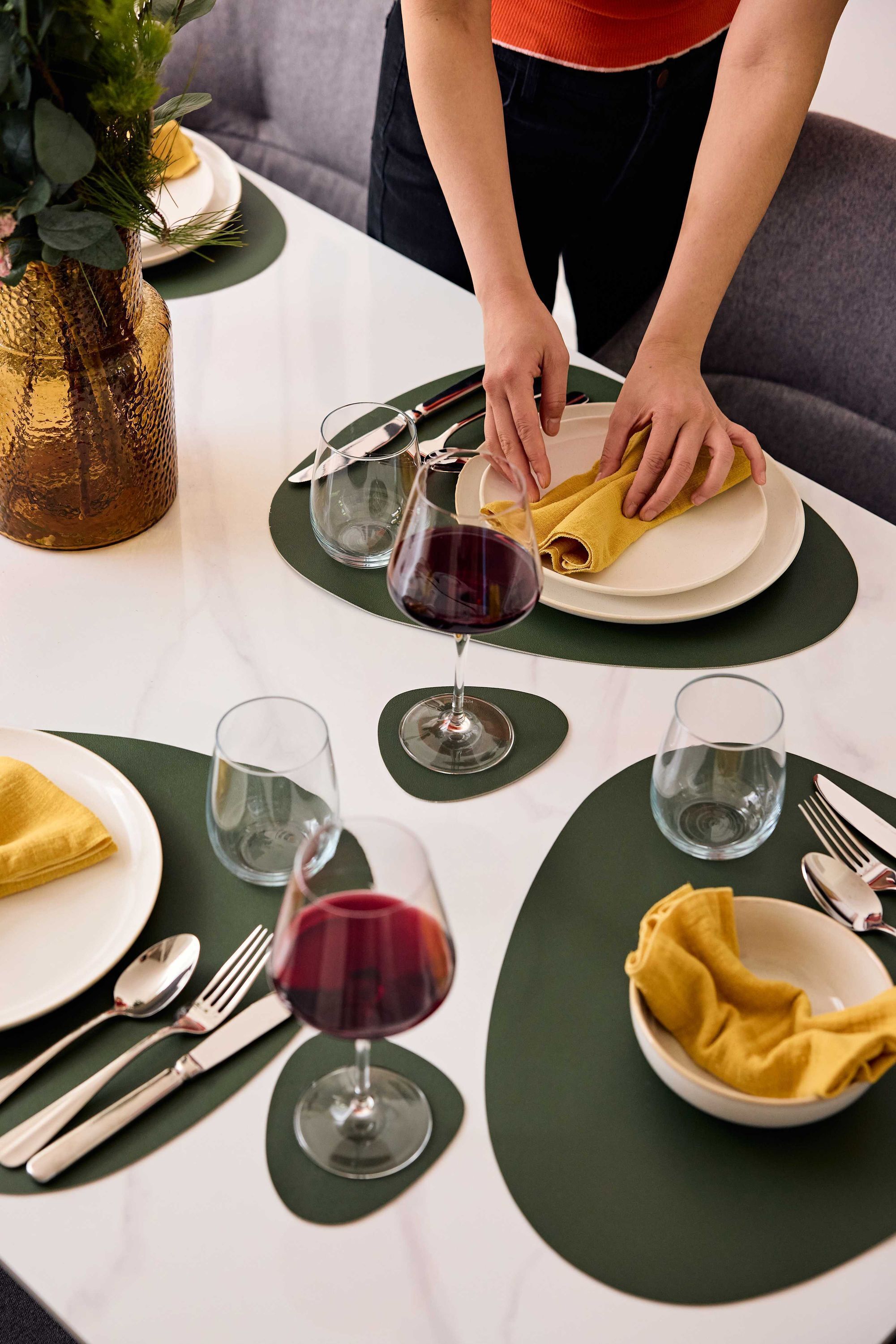 A table set for dining with plates, cutlery, and glasses.