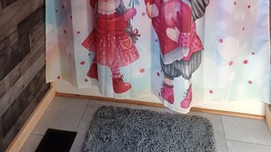 A room with a wooden floor, a gray rug, and a curtain with a heart pattern. - Romantic couples bed & breakfast in secluded Strykersville NY (STRYKERSVILLE)