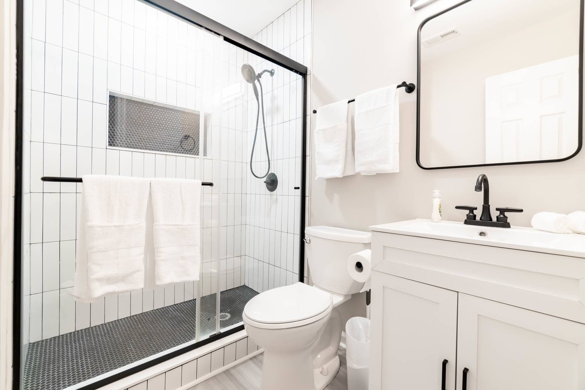 Shower, hair dryer, towels, shampoo