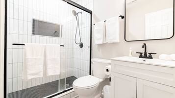 Shower, hair dryer, towels, shampoo