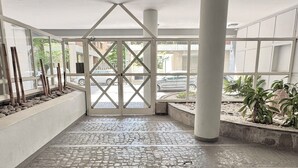 Ein geräumiger Innenbereich mit Fliesenboden, einem zentralen Tor und Topfpflanzen.