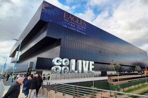 A modern building with a large 'Eagles' sign and 'Go Live' text, indicating a sports venue. - The Eastern Hive - 3x Parking | Co-op Live&Etihad (Greater Manchester)